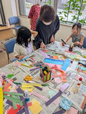 地域の方と七夕飾りを作っている